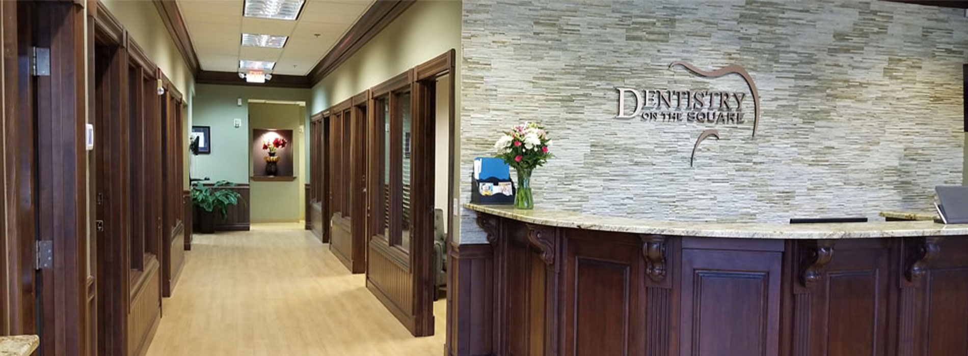 The image shows a modern dental clinic interior with various pieces of equipment, including a dental chair and an X-ray machine.